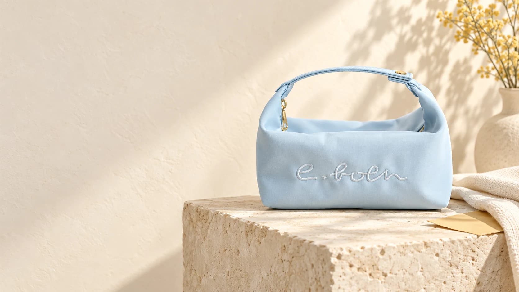 Light blue e.Both pouch in a softly lit studio